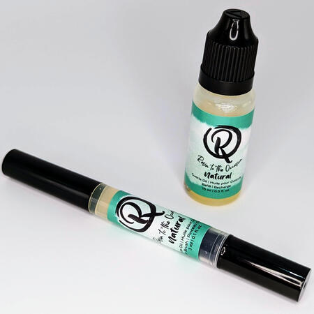 A cuticle brush pen and dropper bottle with a naturally yellow-toned oil inside.